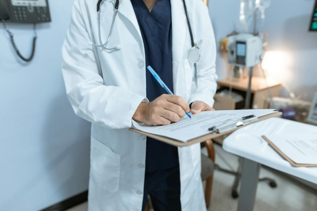 A professional reviewing medical and exposure records on a clipboard