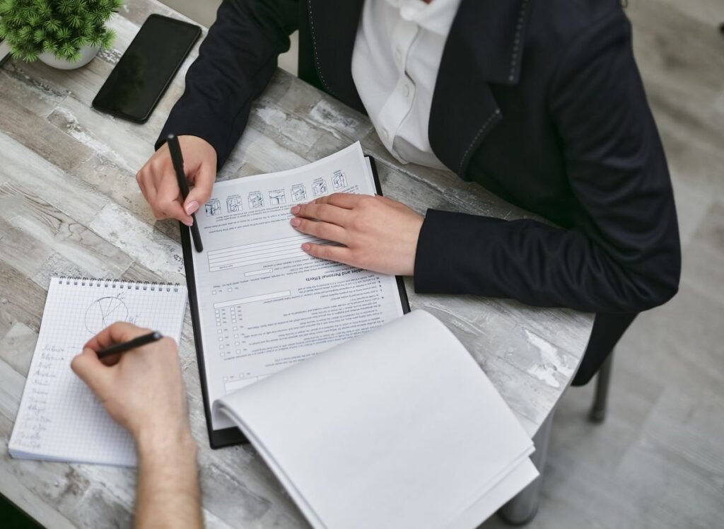Two people reviewing financial documents together during a counseling session