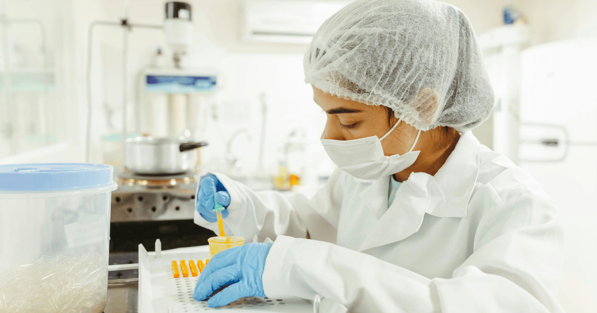 Laboratory technician processing a tissue sample for pathology testing.